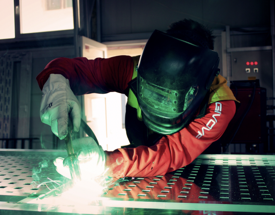 Person welding laser cut aluminum sheet metal
